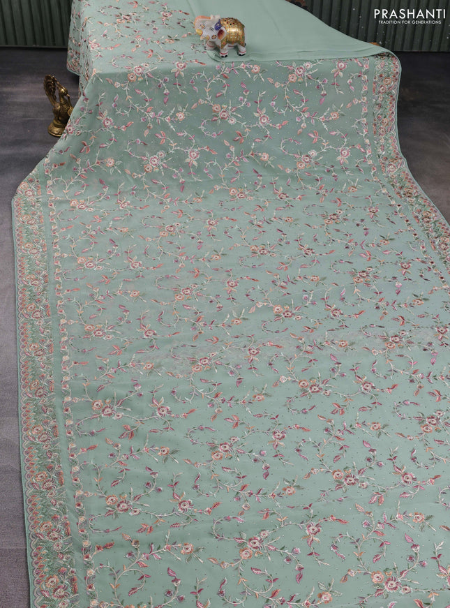 Georgette saree pastel green with allover embroidery stone work and embroidery stone work border
