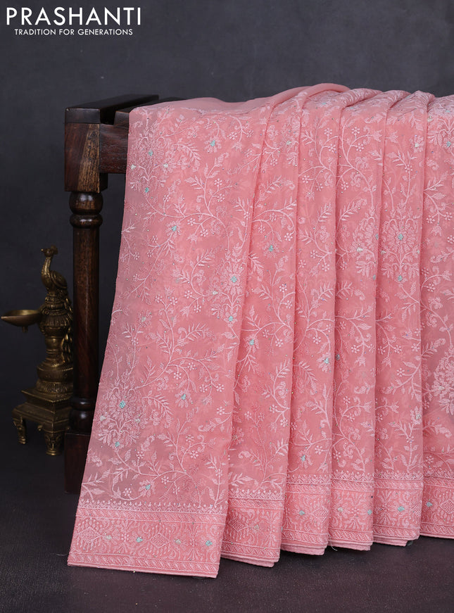 Georgette saree peach shade with allover embroidery work and embroidery border