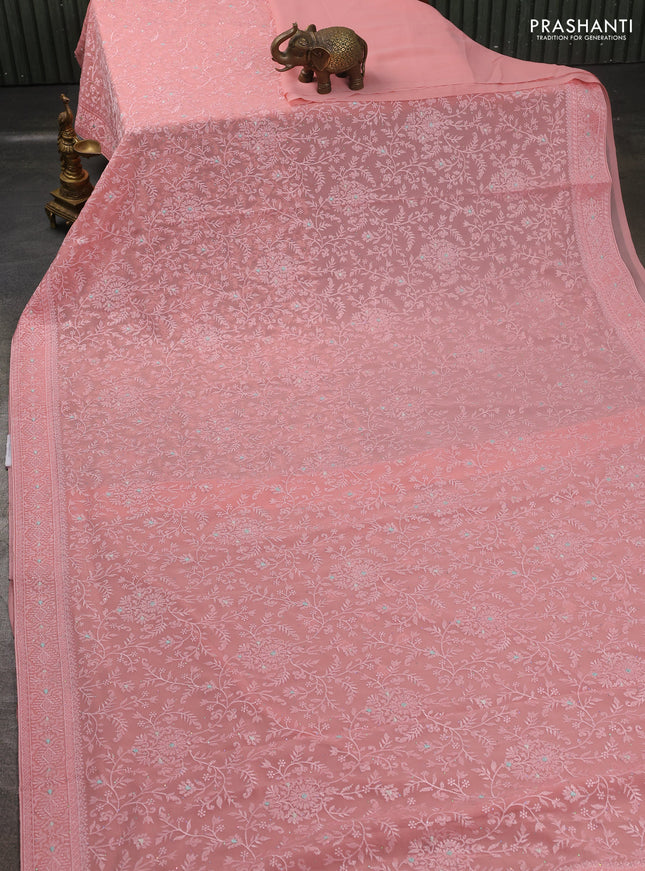 Georgette saree peach shade with allover embroidery work and embroidery border