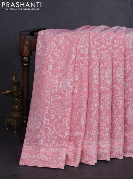 Georgette saree peach shade with allover embroidery work and embroidery border