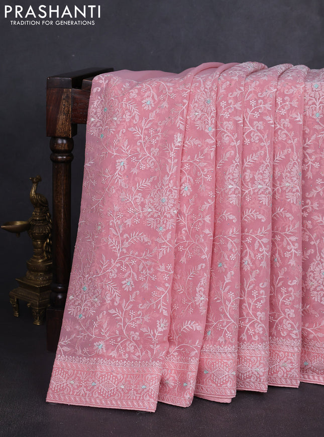 Georgette saree peach shade with allover embroidery work and embroidery border