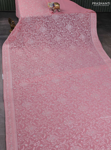 Georgette saree peach shade with allover embroidery work and embroidery border