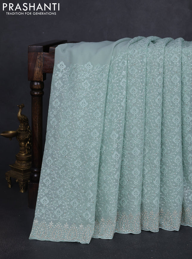 Georgette saree pastel green with allover embroidery work and stone work border