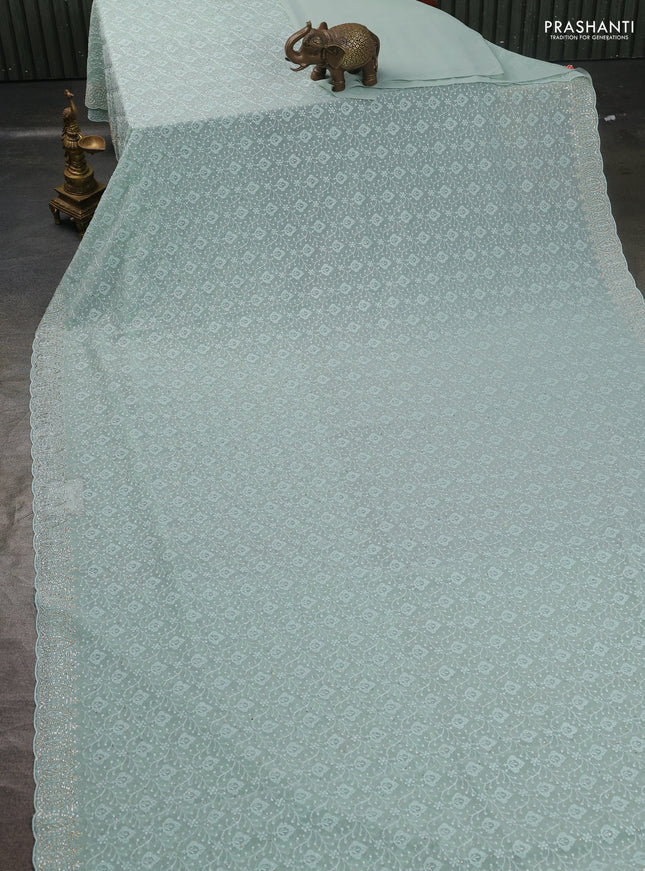Georgette saree pastel green with allover embroidery work and stone work border
