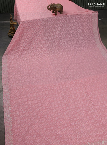Georgette saree peach pink with allover embroidery work and stone work border