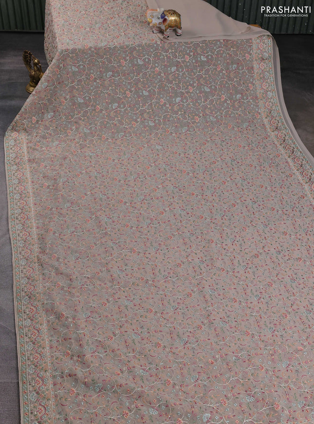 Georgette saree beige with allover embroidery work and embroidery border