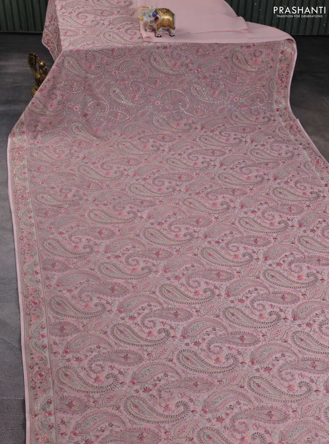Georgette saree peach shade with allover paisley embroidery stone work