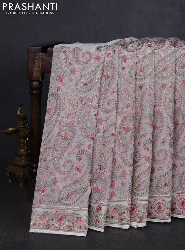Georgette saree off white with allover paisley embroidery stone work