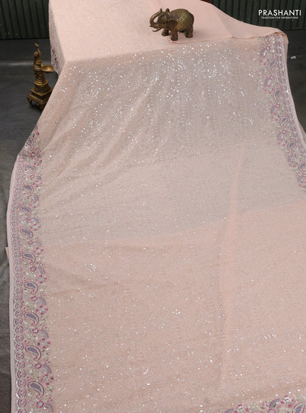 Georgette saree mild peach with allover sequin embroidery work and embroidery stone work border