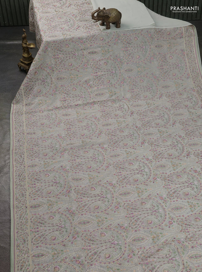 Georgette saree pastel green with allover paisley embroidery stone work