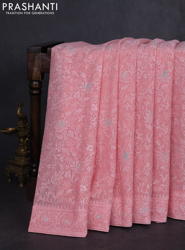 Georgette saree peach shade with allover embroidery work and embroidery border