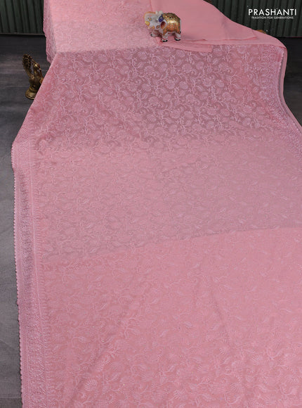Georgette saree peach shade with allover embroidery work and embroidery border