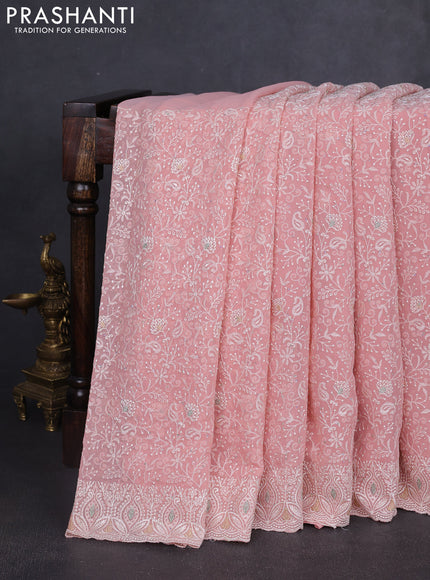 Georgette saree peach shade with allover embroidery work and embroidery border