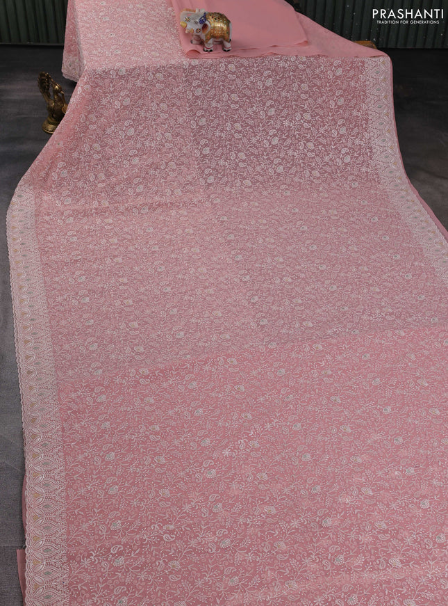 Georgette saree peach shade with allover embroidery work and embroidery border