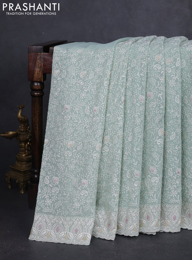 Georgette saree pastel green with allover embroidery work and embroidery border