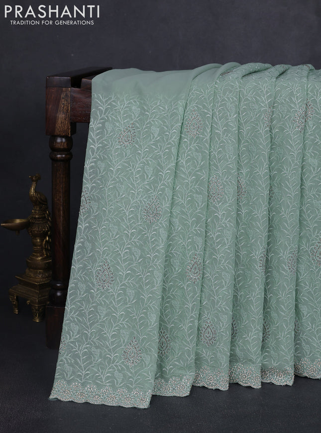Georgette saree pastel green with allover embroidery stone work and stone work border