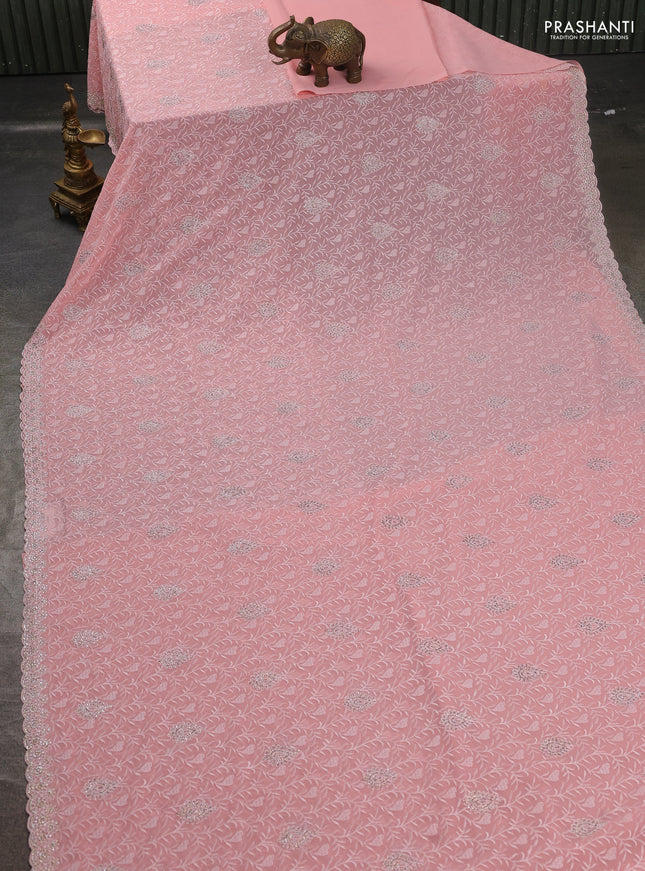 Georgette saree peach shade and  with allover embroidery stone work and stone work border