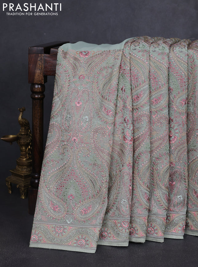 Georgette saree pastel green with allover embroidery stone work and stone work border