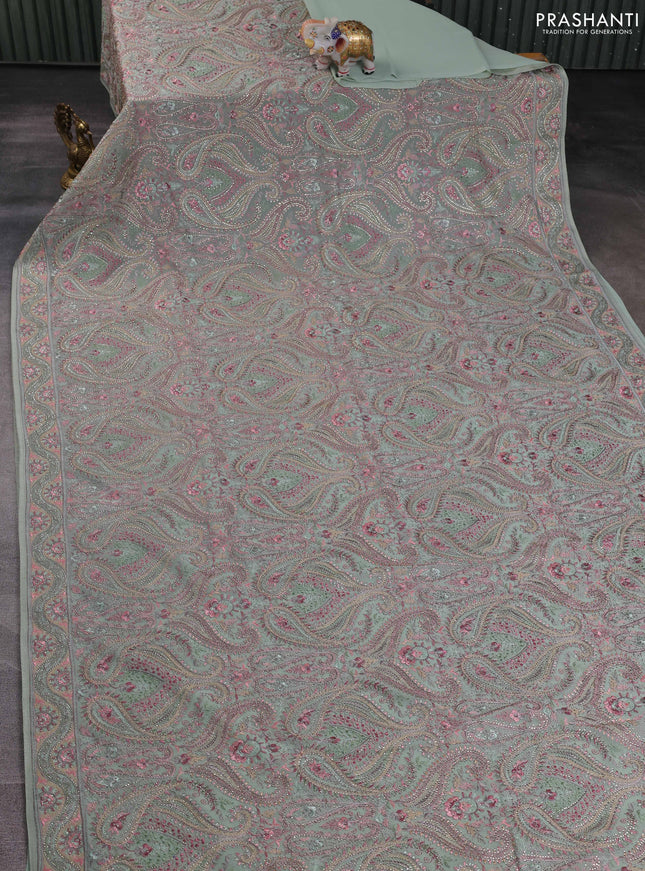 Georgette saree pastel green with allover embroidery stone work and stone work border