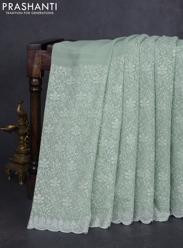 Georgette saree pastel green with allover embroidery work and stone work border