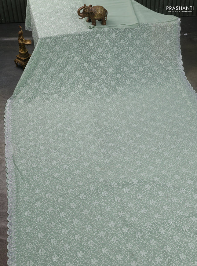 Georgette saree pastel green with allover embroidery work and stone work border