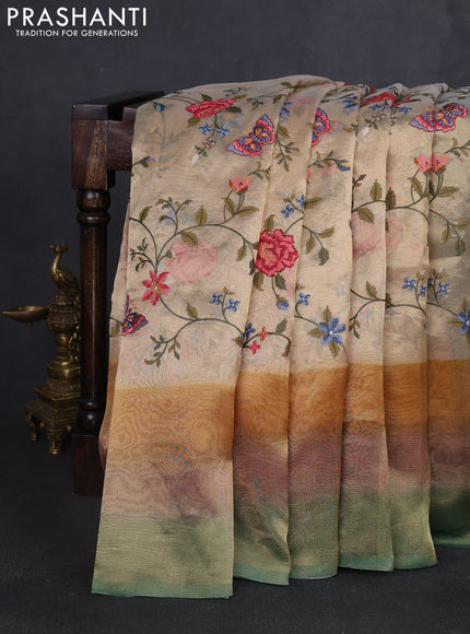 Tissue silk saree beige and green with allover embroidery work and long simple border