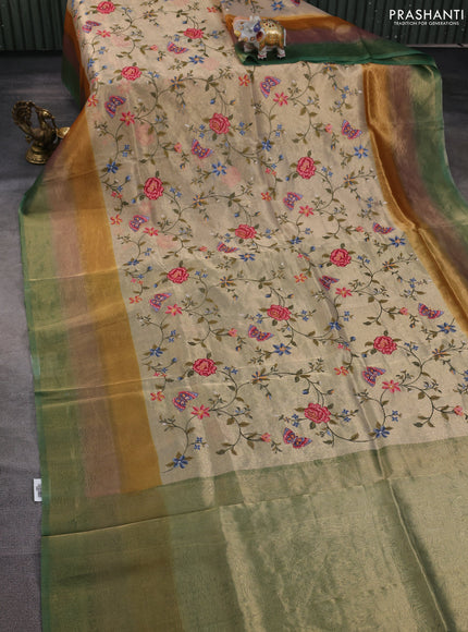 Tissue silk saree beige and green with allover embroidery work and long simple border