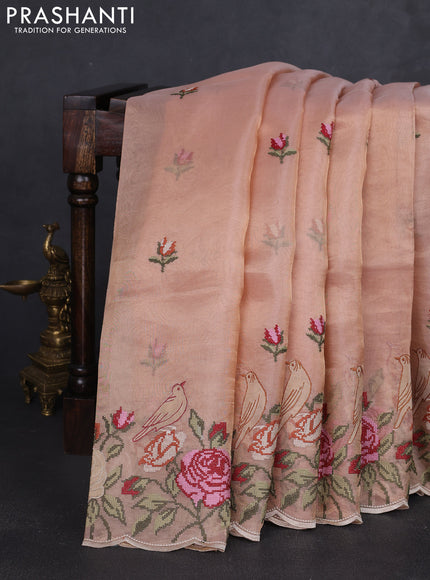 Tissue silk saree pale orange with embroidery buttas and kutch embroidery border