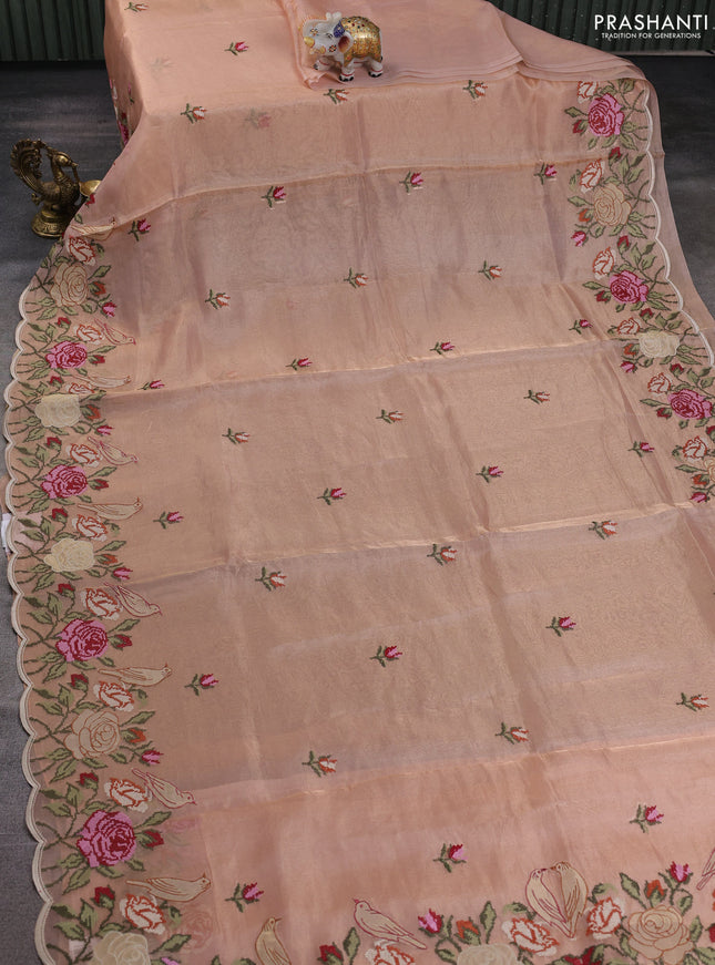 Tissue silk saree pale orange with embroidery buttas and kutch embroidery border