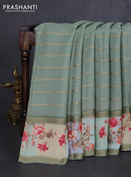 Art chiffon saree pastel green with allover zari stripe pattern and zari woven printed borded