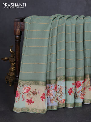 Art chiffon saree pastel green with allover zari stripe pattern and zari woven printed borded