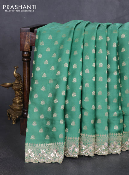 Banarasi silk saree teal green shade with allover zari woven buttas and mirror work embroidery border