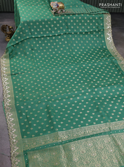 Banarasi silk saree teal green shade with allover zari woven buttas and mirror work embroidery border