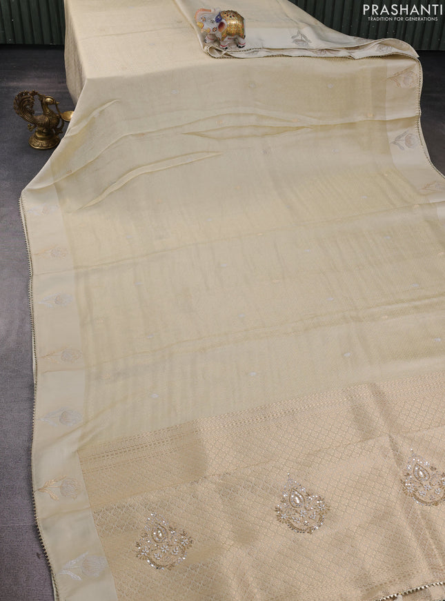 Banarasi silk saree cream with allover zari woven brocade weaves and mirror embroidery pallu & zari woven butta border