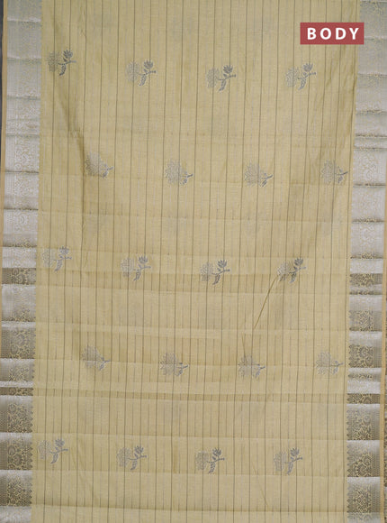 Semi raw silk saree pale yellow with allover thread &zari weaves & buttas and silver zari woven border