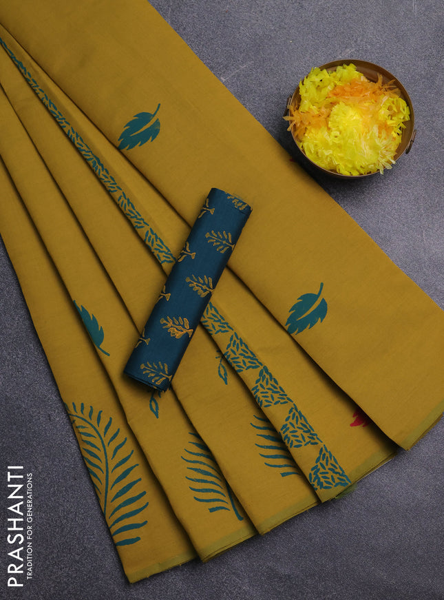 Semi silk cotton saree dark mustard and peacock green with leaf butta prints and butta printed border