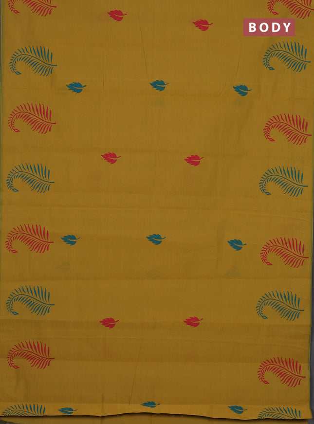 Semi silk cotton saree dark mustard and peacock green with leaf butta prints and butta printed border