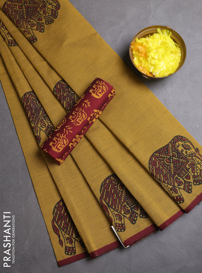 Semi silk cotton saree dark mustard and maroon with elephant butta prints and butta printed border