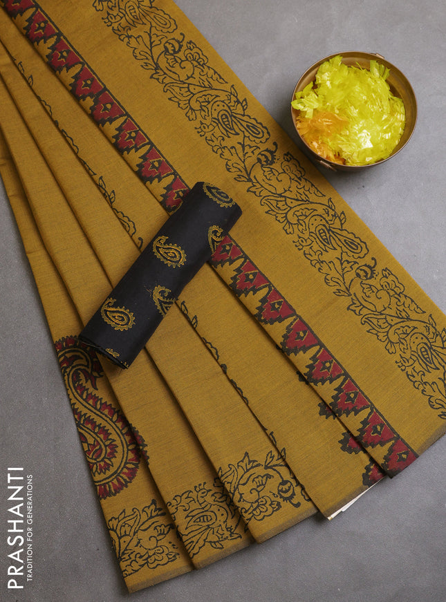 Semi silk cotton saree mustard green shade and black with paisley butta prints and printed border