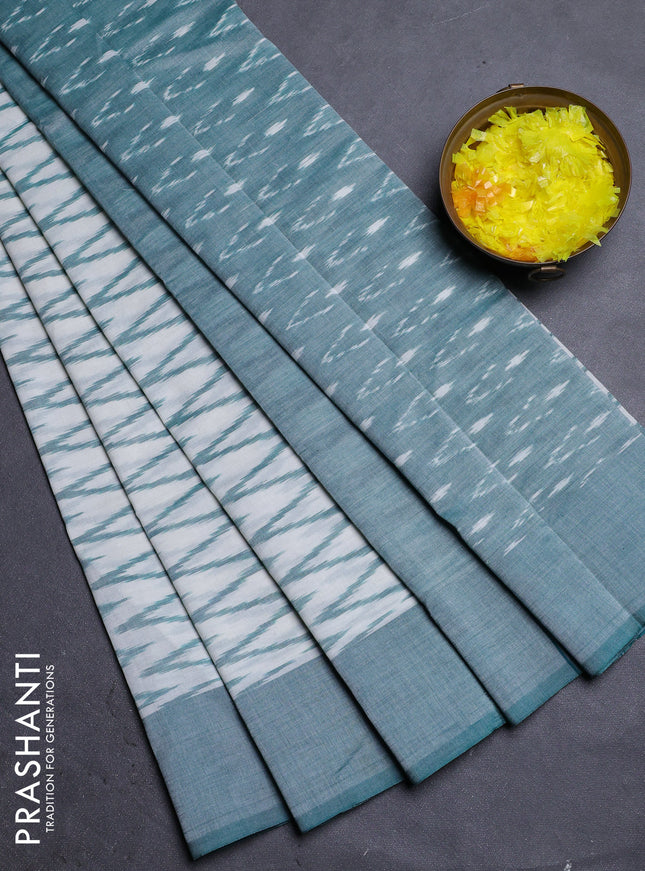 Ikat cotton saree off white and teal green with allover ikat zig zag weaves and simple border