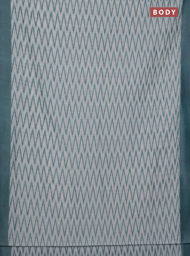 Ikat cotton saree off white and teal green with allover ikat zig zag weaves and simple border
