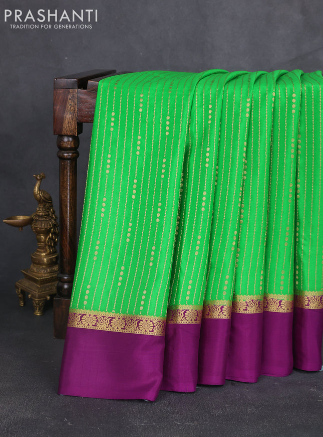 Pure mysore silk sareee green and purple with allover zari weaves and zari woven simple border