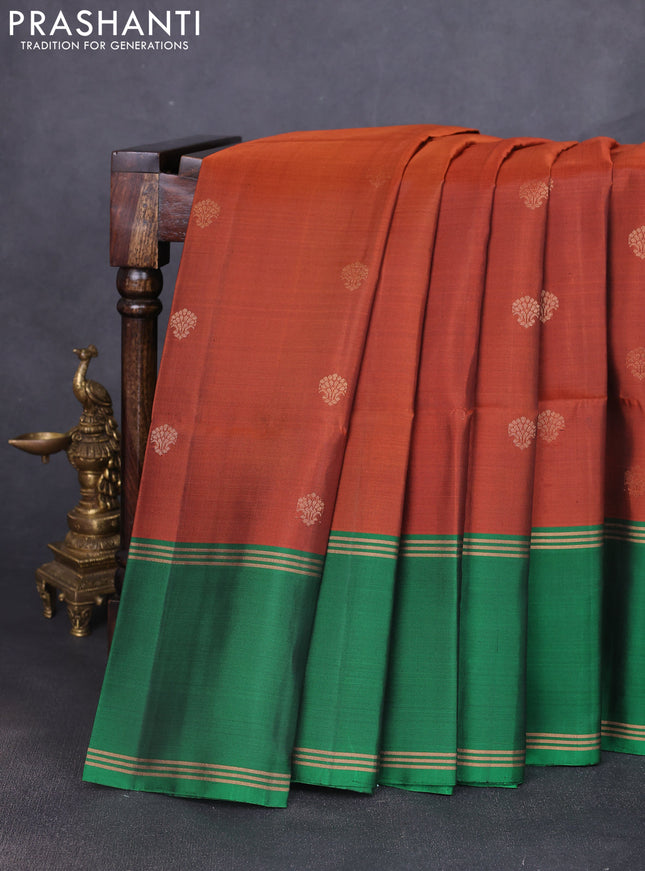 Pure soft silk saree rust shade and green with allover zari woven buttas and long rettapet zari woven border