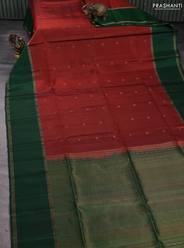 Pure soft silk saree rust shade and green with allover zari woven buttas and rettapet zari woven border