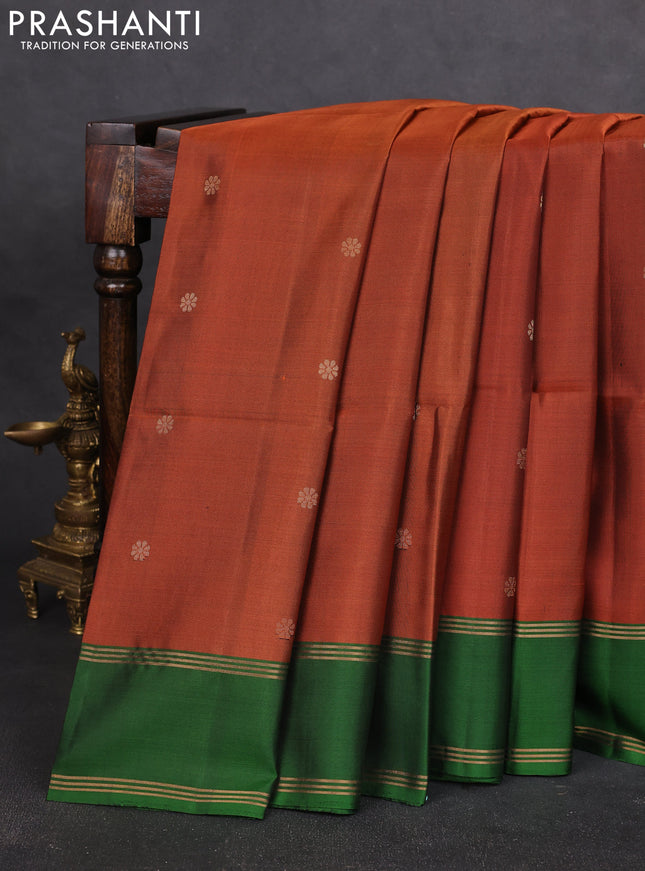 Pure soft silk saree rust shade and green with allover zari woven buttas and rettapet zari woven border