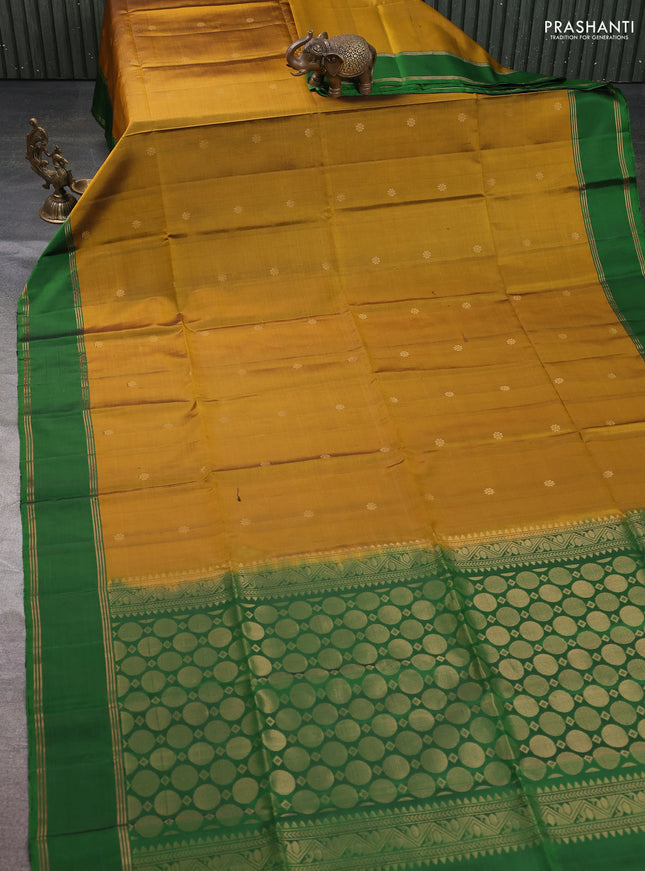 Pure soft silk saree dark mustard and green with allover zari woven buttas and rettapet zari woven border