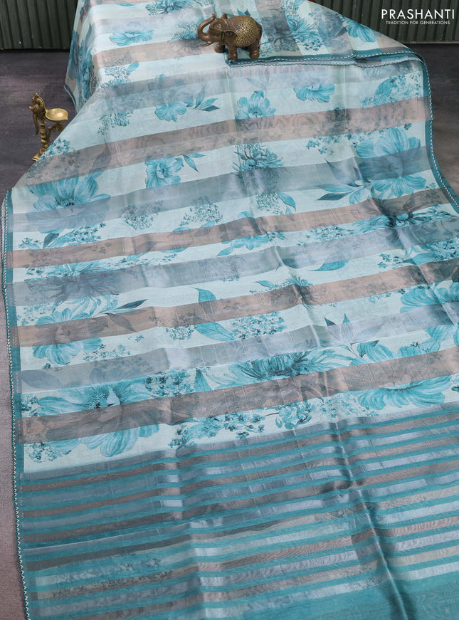 Organza tissue tussar saree teal shade with floral prints and lace work border