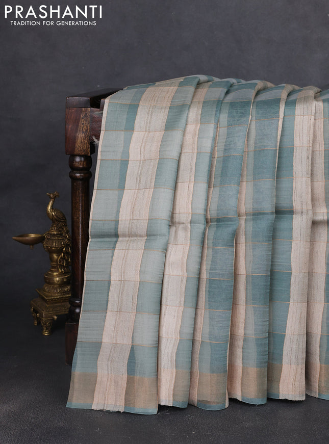 Pure dupion silk saree beige pastel blue and teal blue with allover zari woven checked pattern and concept printed pallu