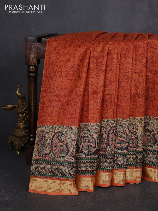 Pure printed silk saree orange with allover prints and madhubani printed zari woven border