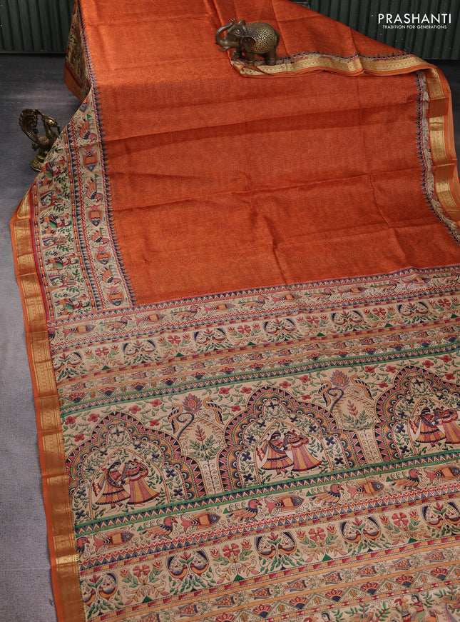 Pure printed silk saree orange with allover prints and madhubani printed zari woven border